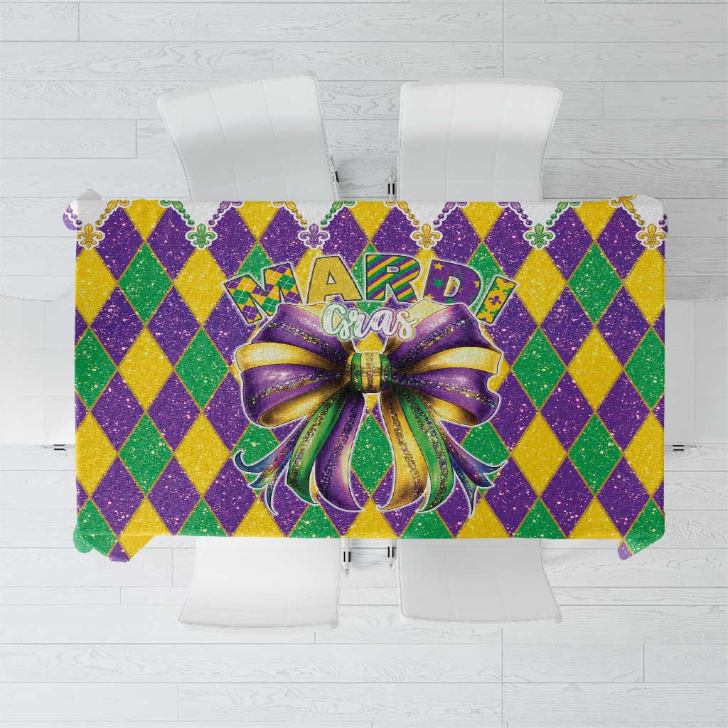 Mardi Gras tablecloth with purple/green/gold diamond pattern and glitter bow centerpiece
