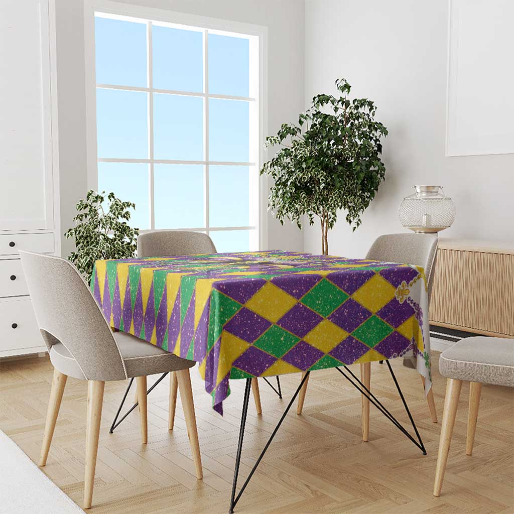 Purple, green, and gold diamond glitter tablecloth with draped corners on a dining table