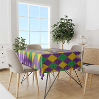 Purple, green, and gold diamond glitter tablecloth with draped corners on a dining table