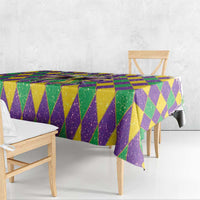 Purple, green, and gold diamond tablecloth with draped edges over a bench table