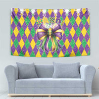 Colorful diamond-pattern Mardi Gras tapestry with shiny purple and gold bow in center