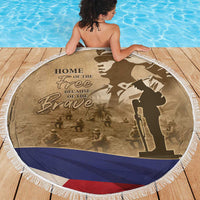 Round brown beach blanket with white fringe, 'HOME OF THE Free' text and soldier silhouette