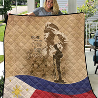 Tan quilt close-up with soldier silhouette, 'Home of the Brave' text, and flag stripes