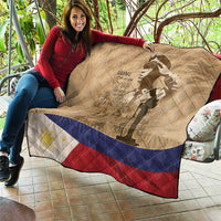 Tan quilt spread out with soldier silhouette, flag stripes band, and diamond quilting