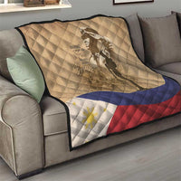 Tan quilt draped on sofa with soldier silhouette, flag stripes band, and diamond quilting