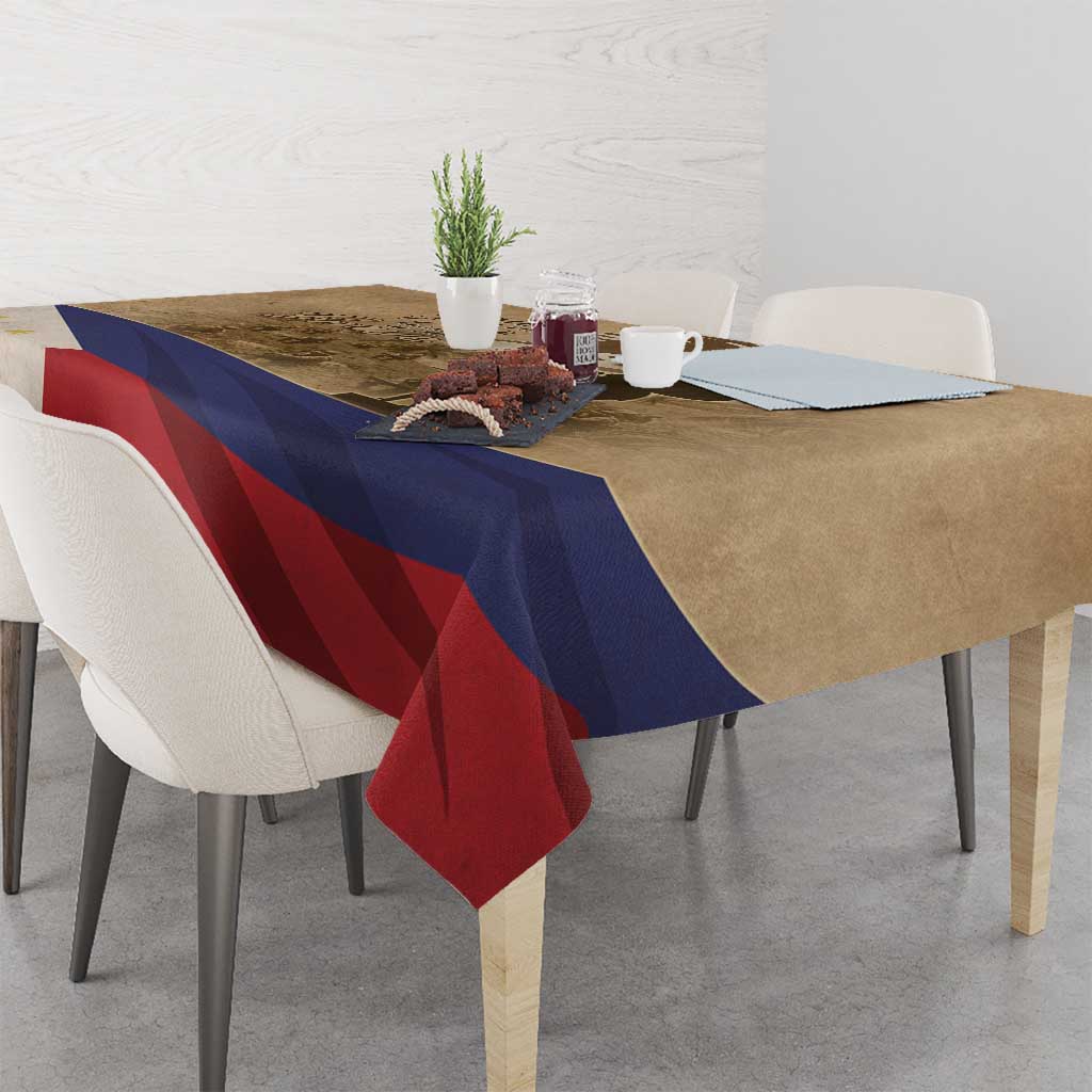 Brown commemorative tablecloth draped over dining table with blue and red stripes