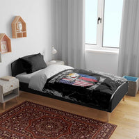 Black bedding set with flag-and-cross graphic duvet on bed with two black pillowcases