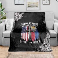 Black grunge style throw blanket with cross and flag graphic, folded over sofa