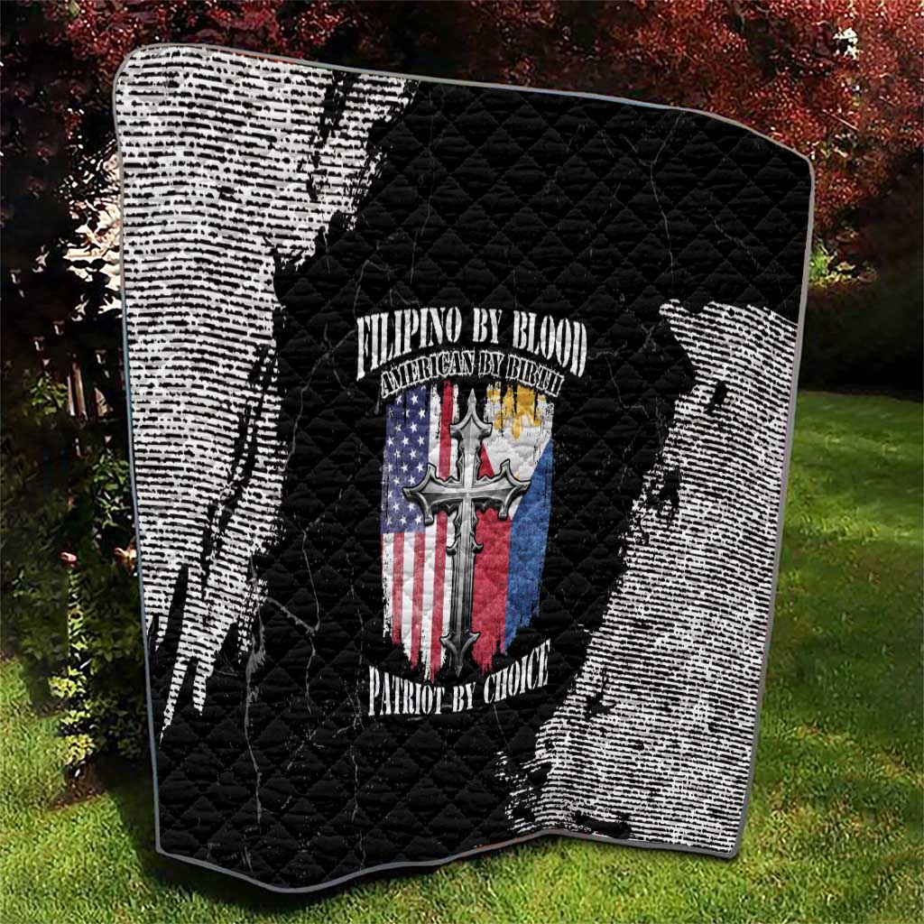 Black and white grunge quilt with quilted diamonds and centered patriotic emblem, laid outdoors