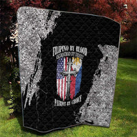 Black and white grunge quilt with quilted diamonds and centered patriotic emblem, laid outdoors
