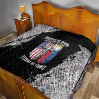 Black and white quilt on a bed, quilted diamonds with centered patriotic emblem