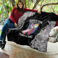 Black and white quilt draped on a sofa chair, featuring quilted diamonds and patriotic crest