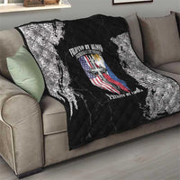 Black and white quilt blanket on a living room sofa, quilted diamonds with patriotic emblem