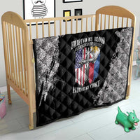 Black and white quilt on a wooden crib bed, quilted diamonds with patriotic crest