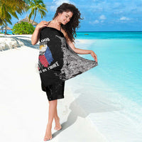 Black and white grunge print sarong wrap with partial crest graphic visible