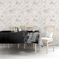 Black grunge-style tablecloth with distressed striped graphic print on dining table surface