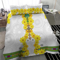 White duvet cover with yellow flower cross design, matching pillowcases, and patterned bottom border