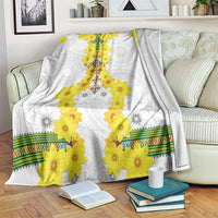 White fleece blanket with yellow flower tillet pattern and green stripe border