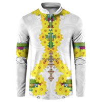 White button sweatshirt front view with yellow floral centerpiece and multicolor embroidery trim.