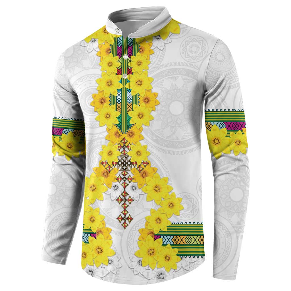 White long-sleeve sweatshirt with yellow floral motif and multicolor striped sleeve bands.