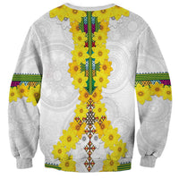 Unisex white crewneck sweatshirt with yellow flower garland motif and multicolor central stripe