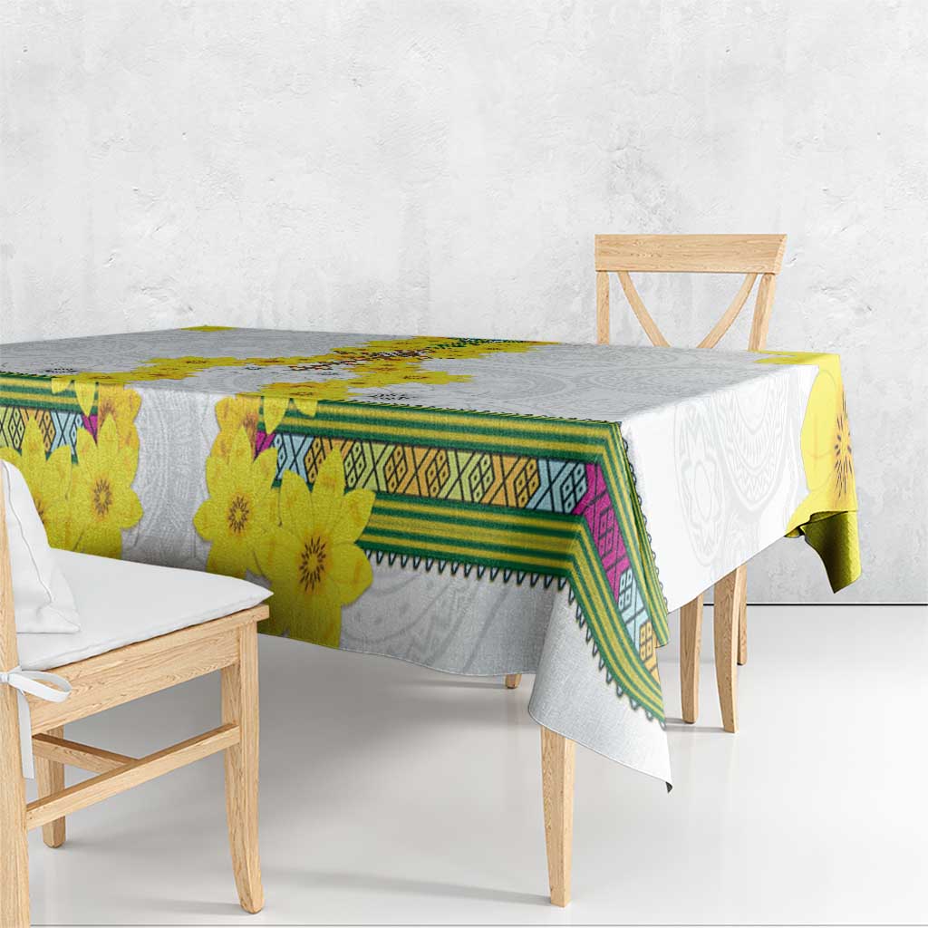 White tablecloth with yellow blossoms, green frame pattern, and purple accents