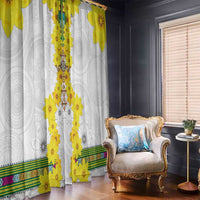 White window curtain with yellow floral tile pattern and dangling flower accents