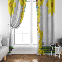 White window curtain with yellow vertical floral trim, gathered and draped near window