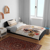 Beige and cream bedding set on bed with horse racing print, roses, and diamond pattern pillows