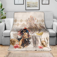 Light beige Kentucky Derby 151st blanket draped over sofa, featuring horse and roses
