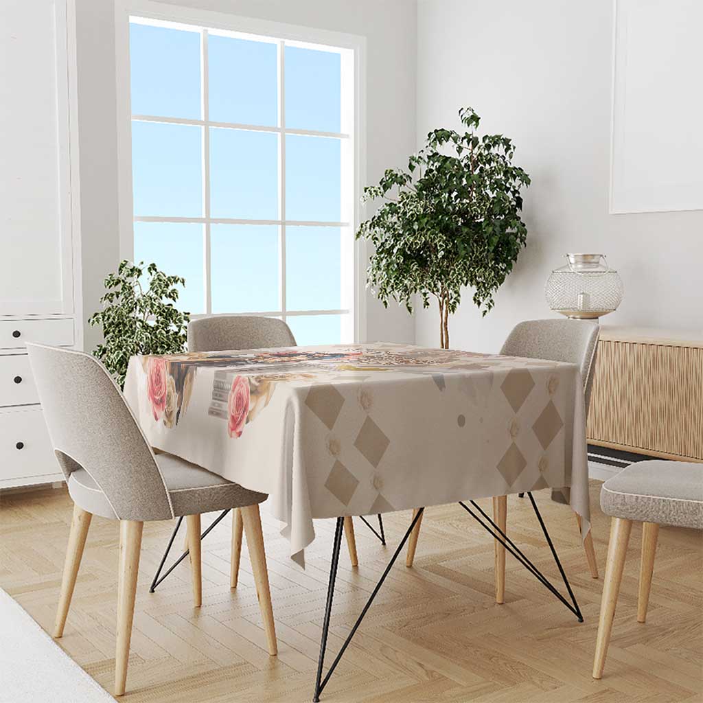 Beige tablecloth on dining table with diamond pattern and rose prints.
