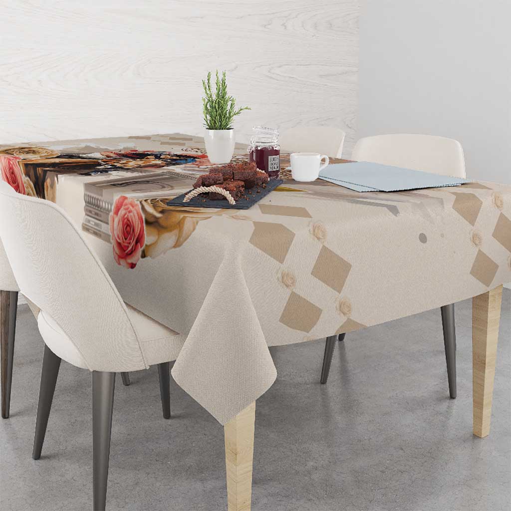 Beige tablecloth with diamond pattern and rose artwork along the folded edge.