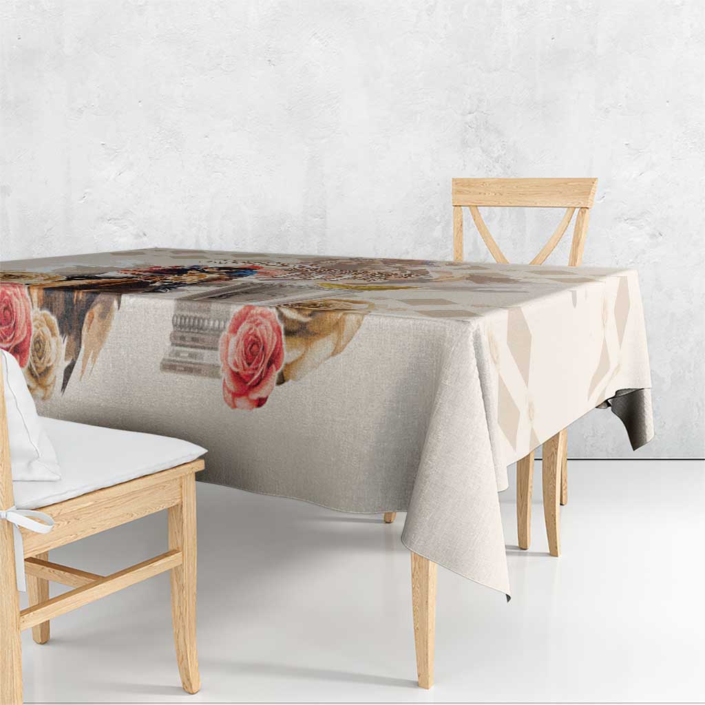 Beige tablecloth draped over a table, showing rose print and diamond accents.
