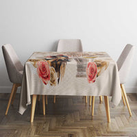 Beige tablecloth on a round dining table with rose and diamond design.