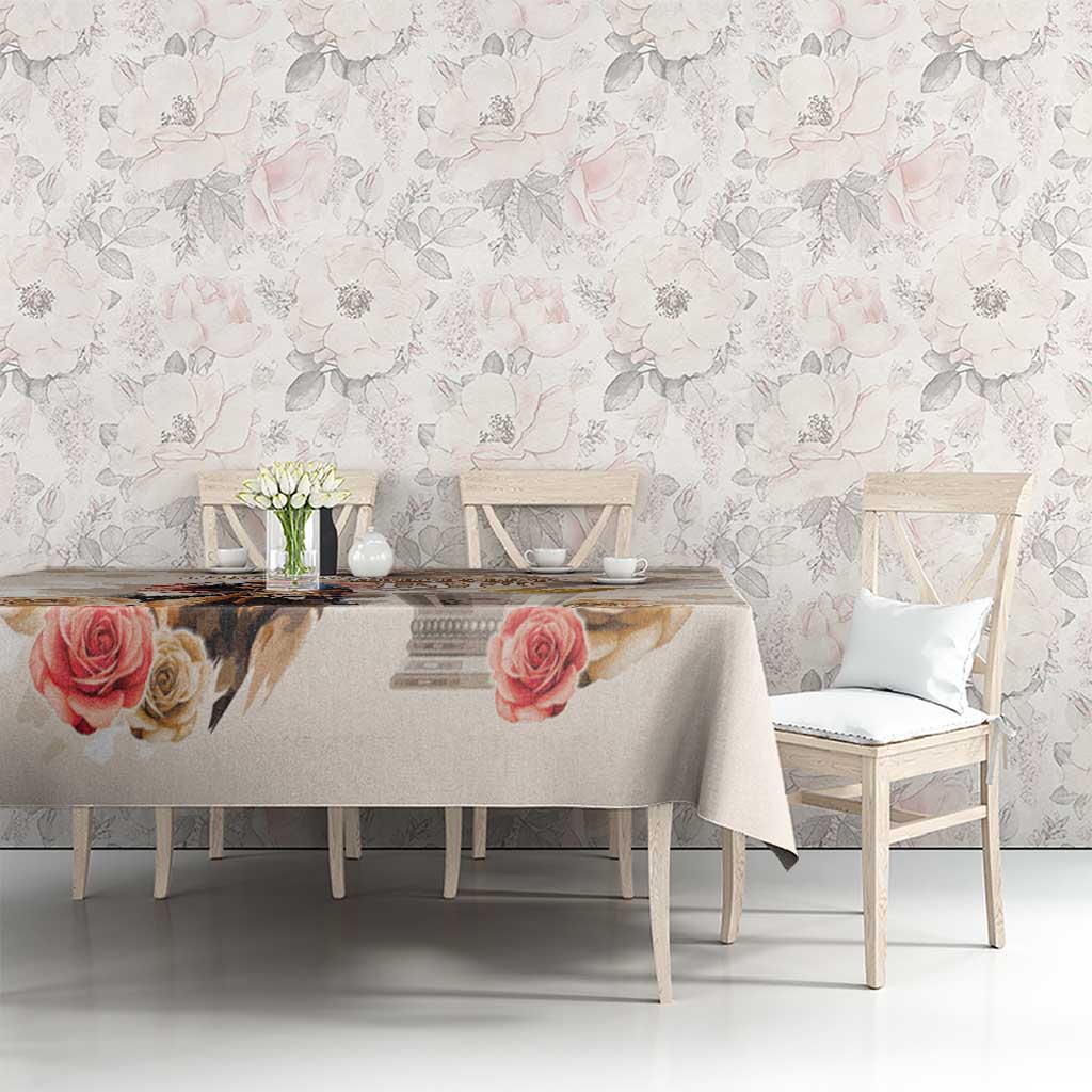 Beige tablecloth with rose print and subtle diamond pattern on a dining table.