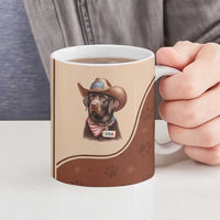 Brown ceramic mug with cowboy dog USA graphic, held with fingers; hot drink inside