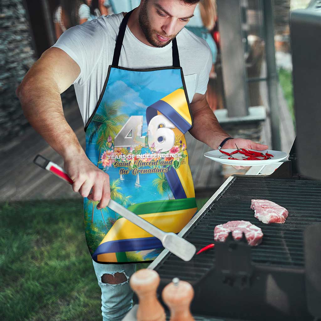 Blue independence apron with white straps and “46 years” graphic print, tied at neck and waist