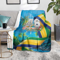 Blue flag-themed throw blanket on gray couch with 46 Years of Independence bird graphic