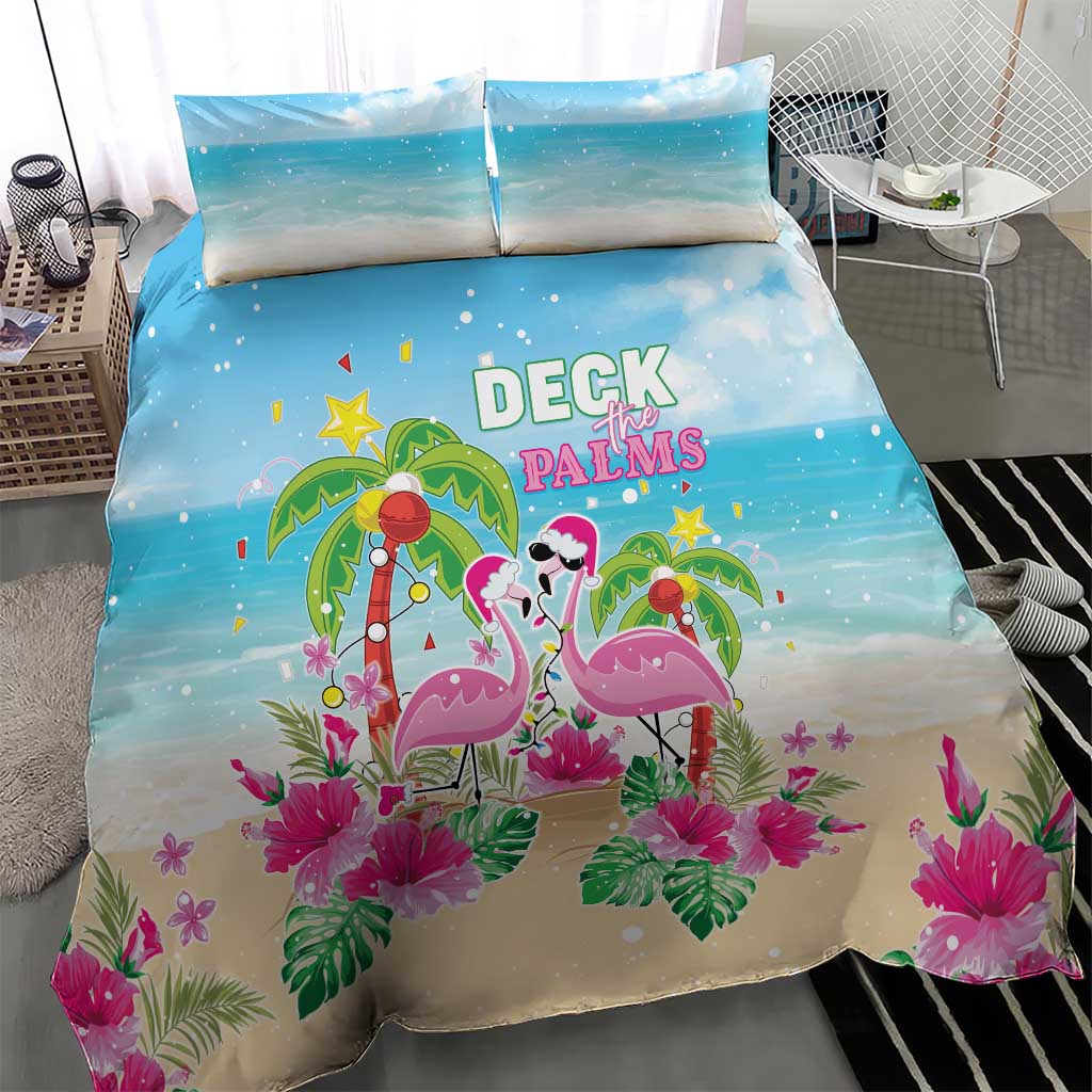 Blue and beige holiday bedding set featuring flamingo duo, palms, and pink flowers