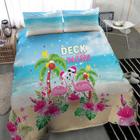 Blue and beige holiday bedding set featuring flamingo duo, palms, and pink flowers