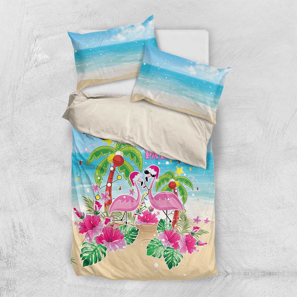 Blue and beige printed bedding set with flamingos, palms, and matching pillow shams