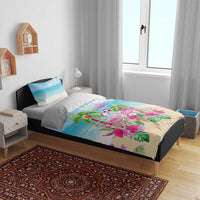 Blue and beige flamingo and palm bedding set on bed with two pillow shams