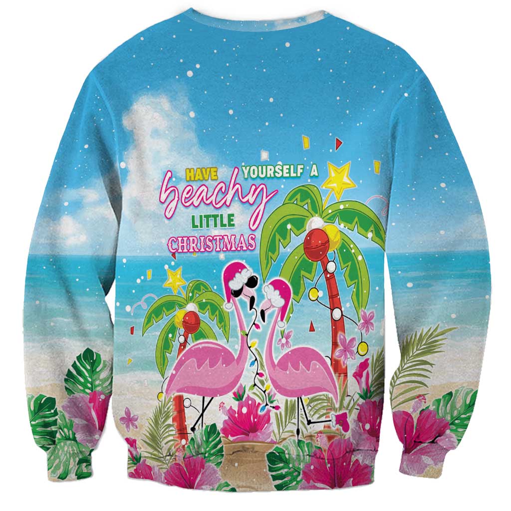 Blue crewneck sweatshirt with flamingos, palms, and Have yourself a beachy little Christmas text