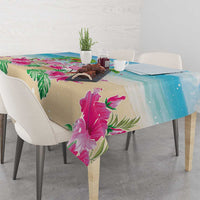 Blue and beige tablecloth with pink flamingo and green palm leaf print