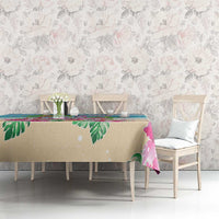 Blue and beige tablecloth featuring flamingos and palm leaf pattern