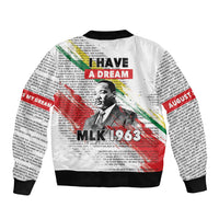 Unisex white bomber jacket with black ribbed cuffs, hem, and large back MLK 1963 print