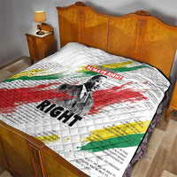 White quilt with diamond stitching, Martin Luther King portrait, and red-green-yellow stripe design