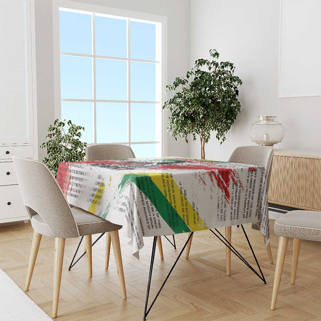 White tablecloth with Martin Luther King Jr portrait, rainbow text, and draped edges