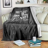 Black MLK portrait blanket with bold white text, draped over sofa