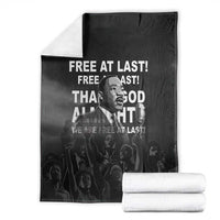 Black MLK portrait blanket with bold white text, folded bundle with two stacks